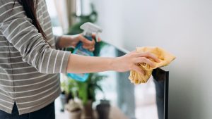 Cropped shot of a young woman cleaning the surface of a TV with cleaning spray and antistatic cloth at home during the day
